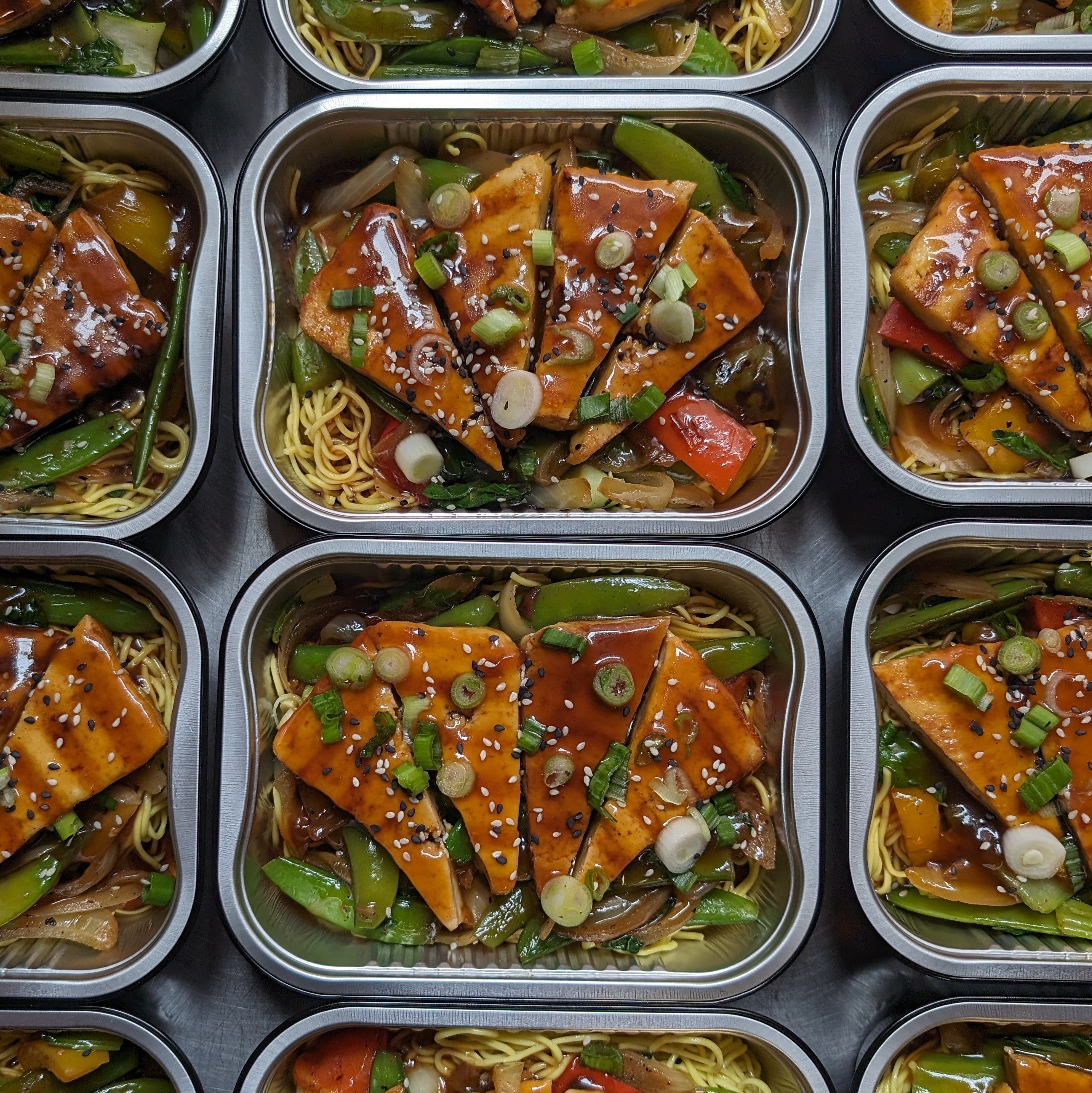 Asian marinated beef on noodles and vegetable sauté