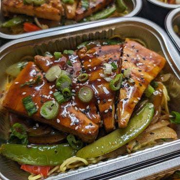 Asian marinated beef on noodles and vegetable sauté