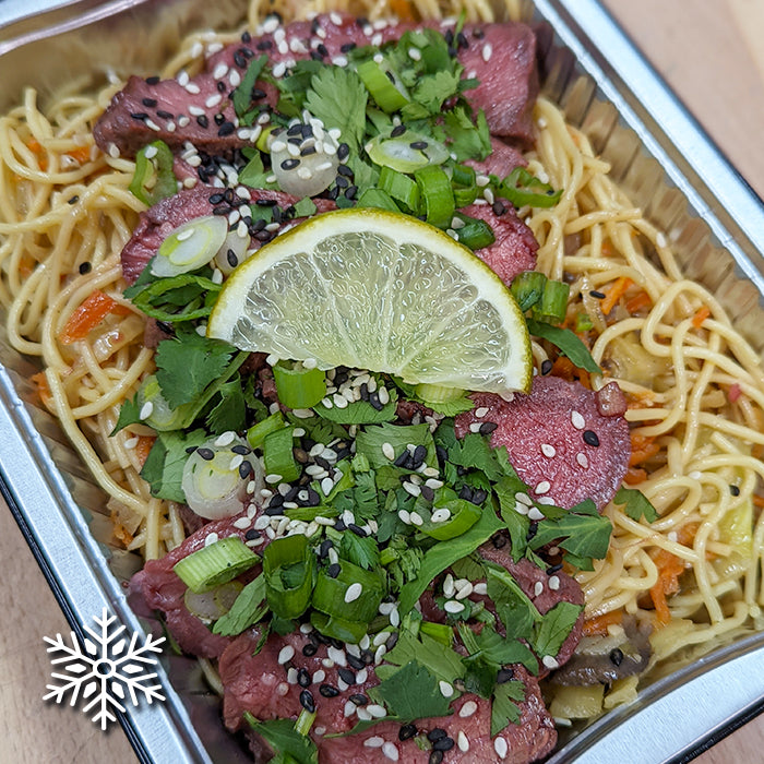 Asian marinated beef on noodles and vegetable sauté
